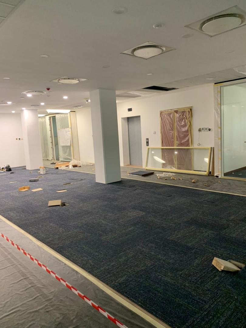 Carpet tiles being laid across an office floor