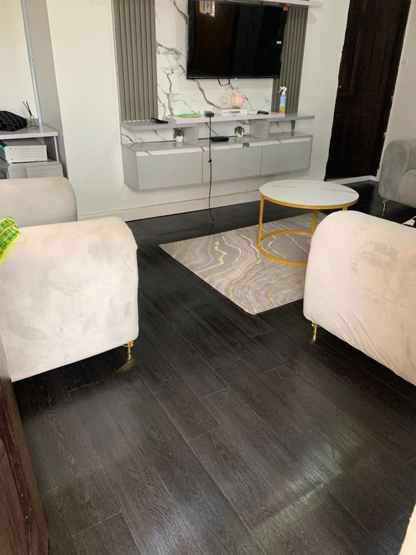 Dark wood flooring in a finished lounge