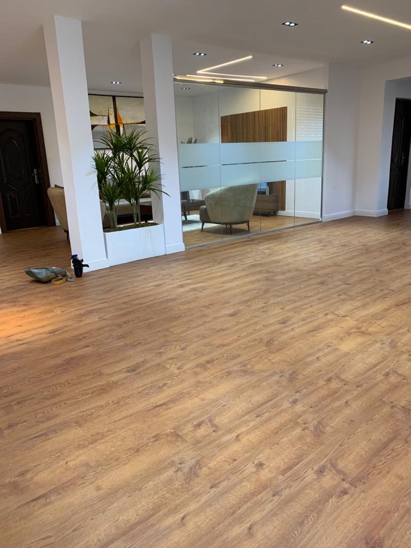 Light wood flooring running through an open-plan room