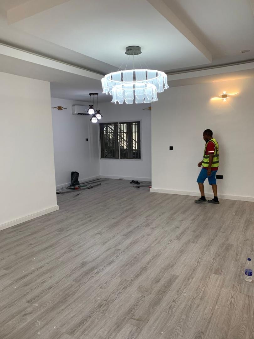Grey wide-plank flooring in a newly completed room
