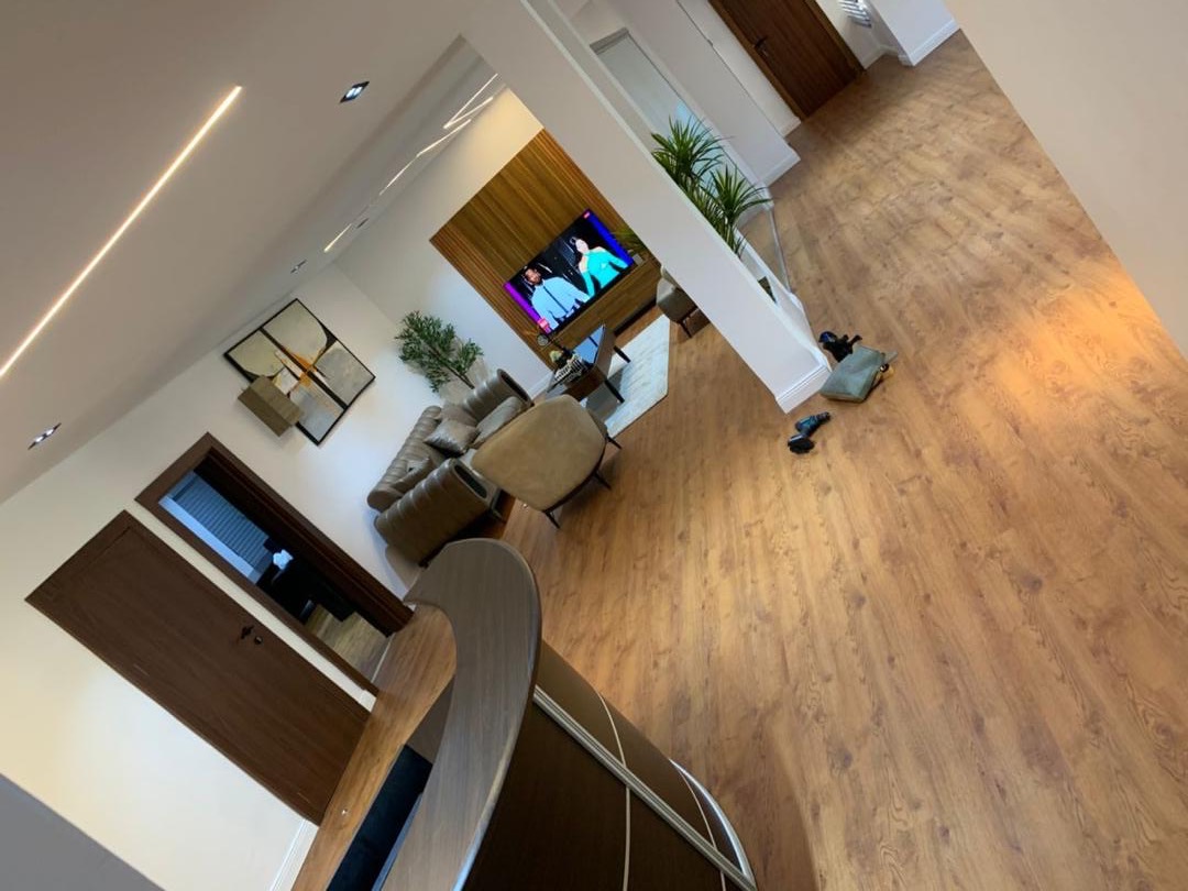 Open-plan living area seen from the landing, warm wood flooring throughout
