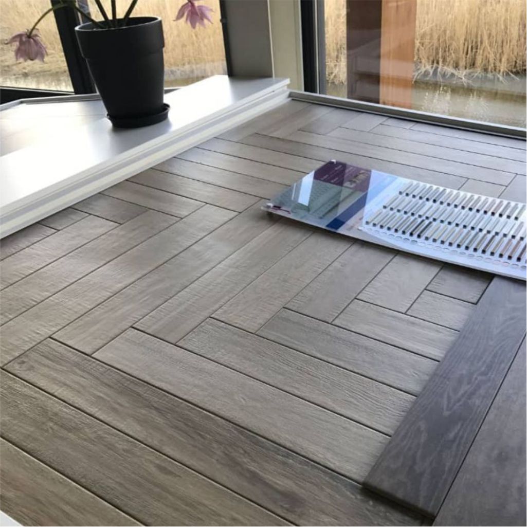 Herringbone wood-effect vinyl with a sample book laid on top